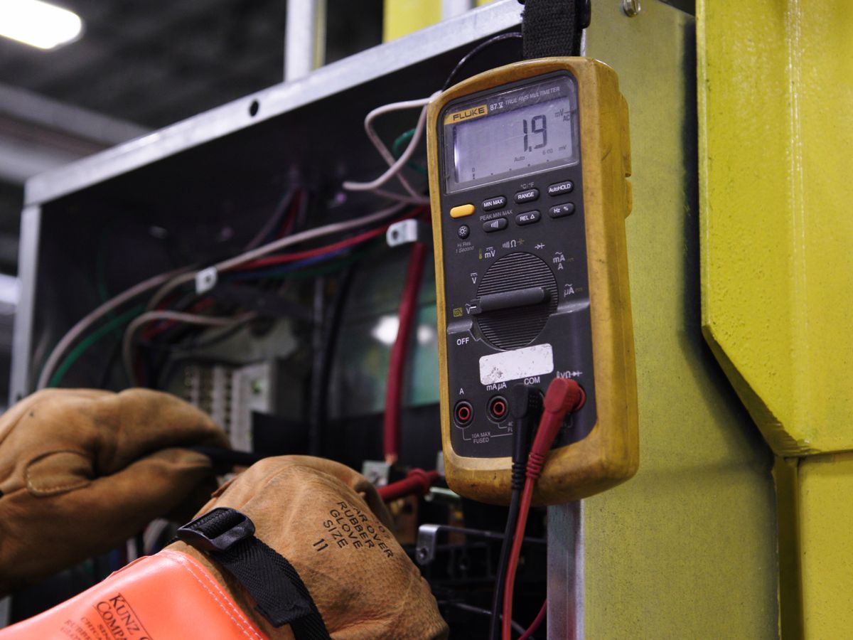 Arcwell electrician measuring existing panel load capacity