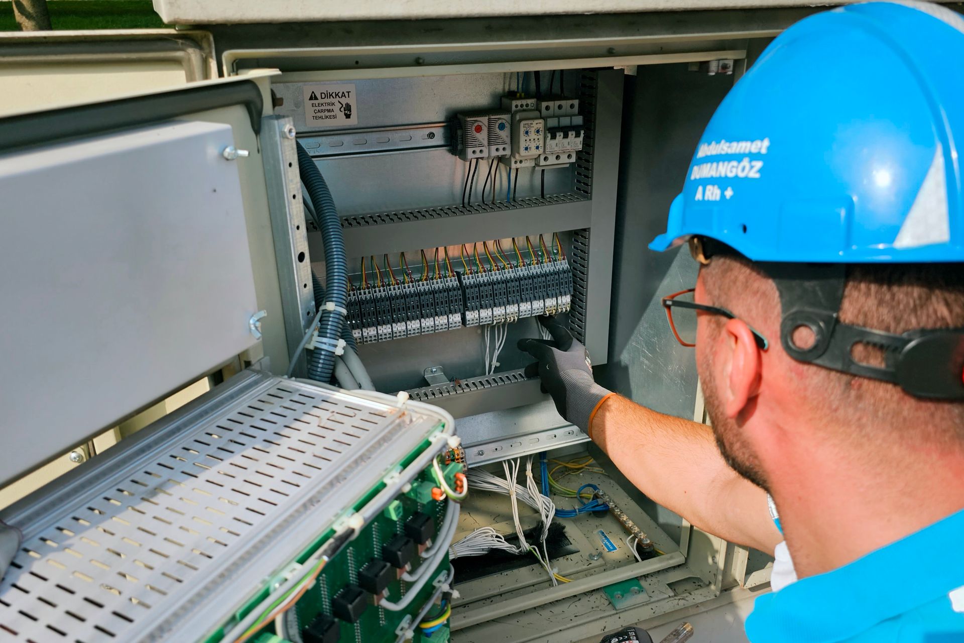 Emergency electrician attending an outdoor switchboard make-safe at night